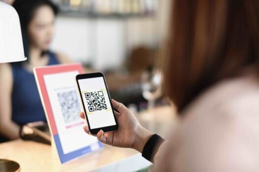 A woman uses mobile payments on her smart phone