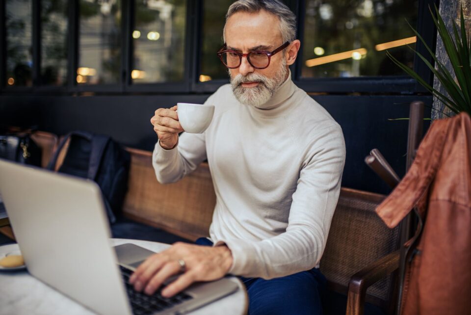 A man amking cross border payments at cafe