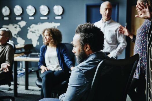 Businessman listening during team meeting on international expansion