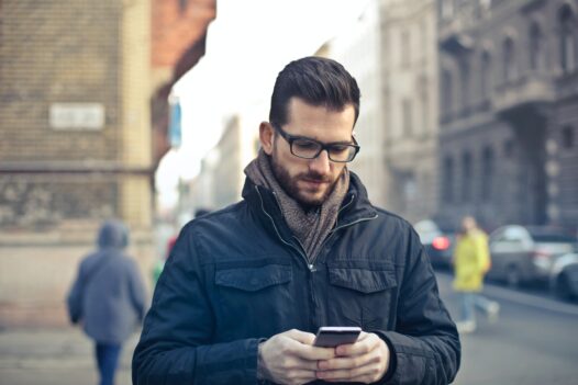 Man holds cellphone in a European city