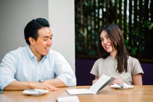 man and woman discuss payment solutions