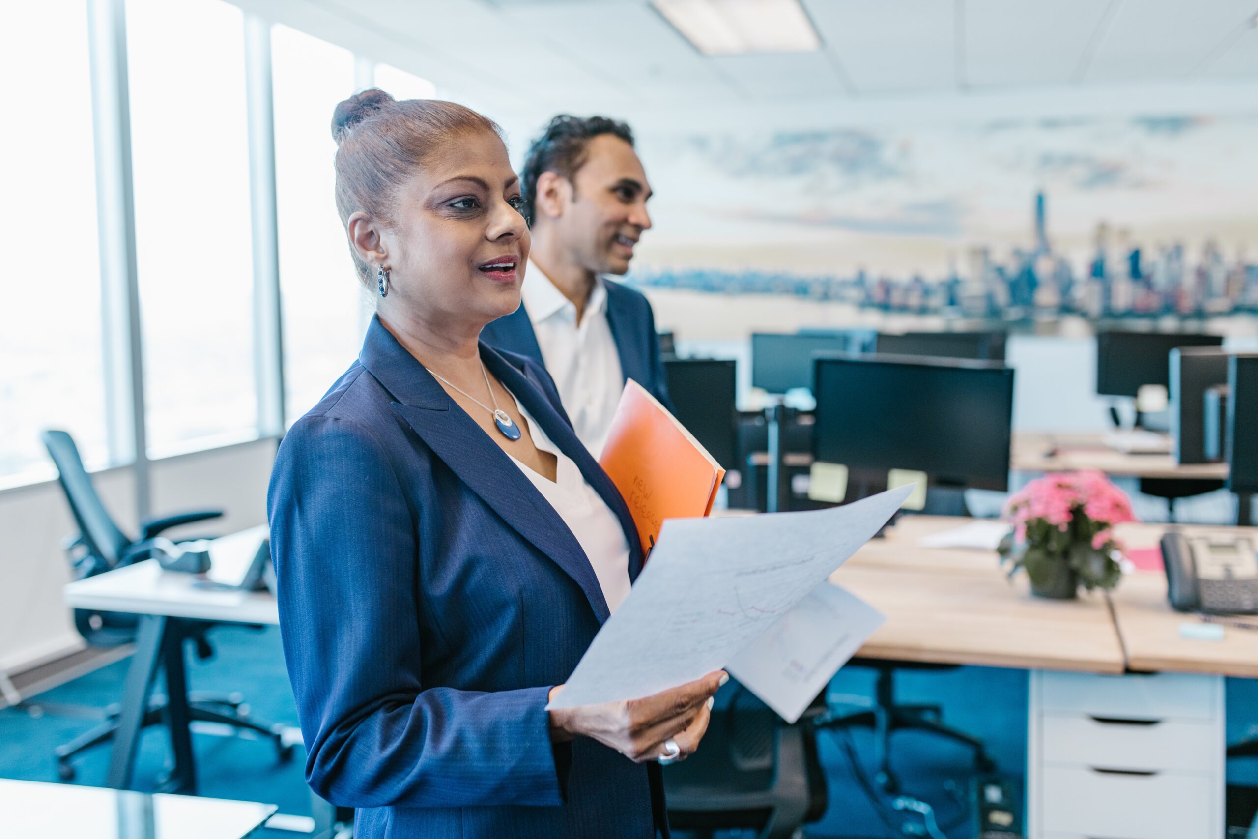 Business woman holding papers discussing global payments