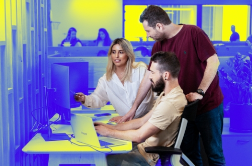 Image of Employees Gathered Around a Monitor