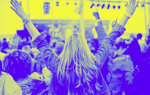 A woman cheers in a crowd at an event made possible with a chip and pin machine available for short-term hire.