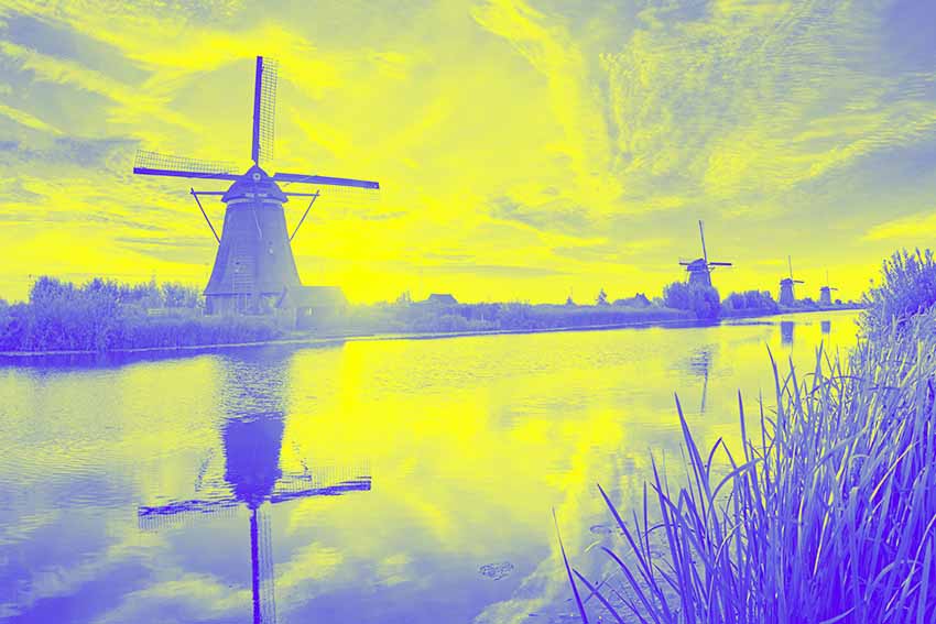 Landscape with a windmill representing the most popular payment methods in the Netherlands.