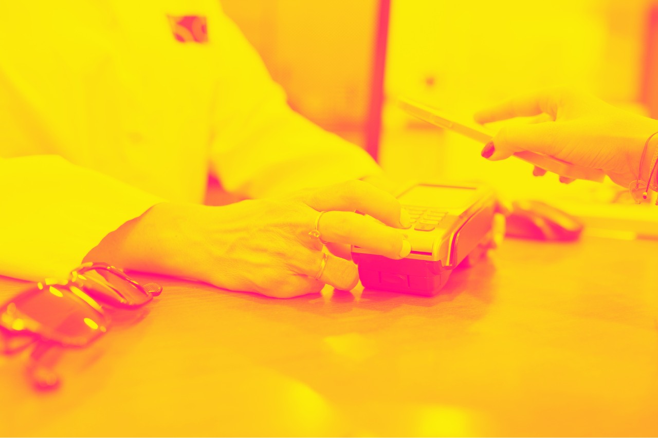 A woman pays through a payment terminal