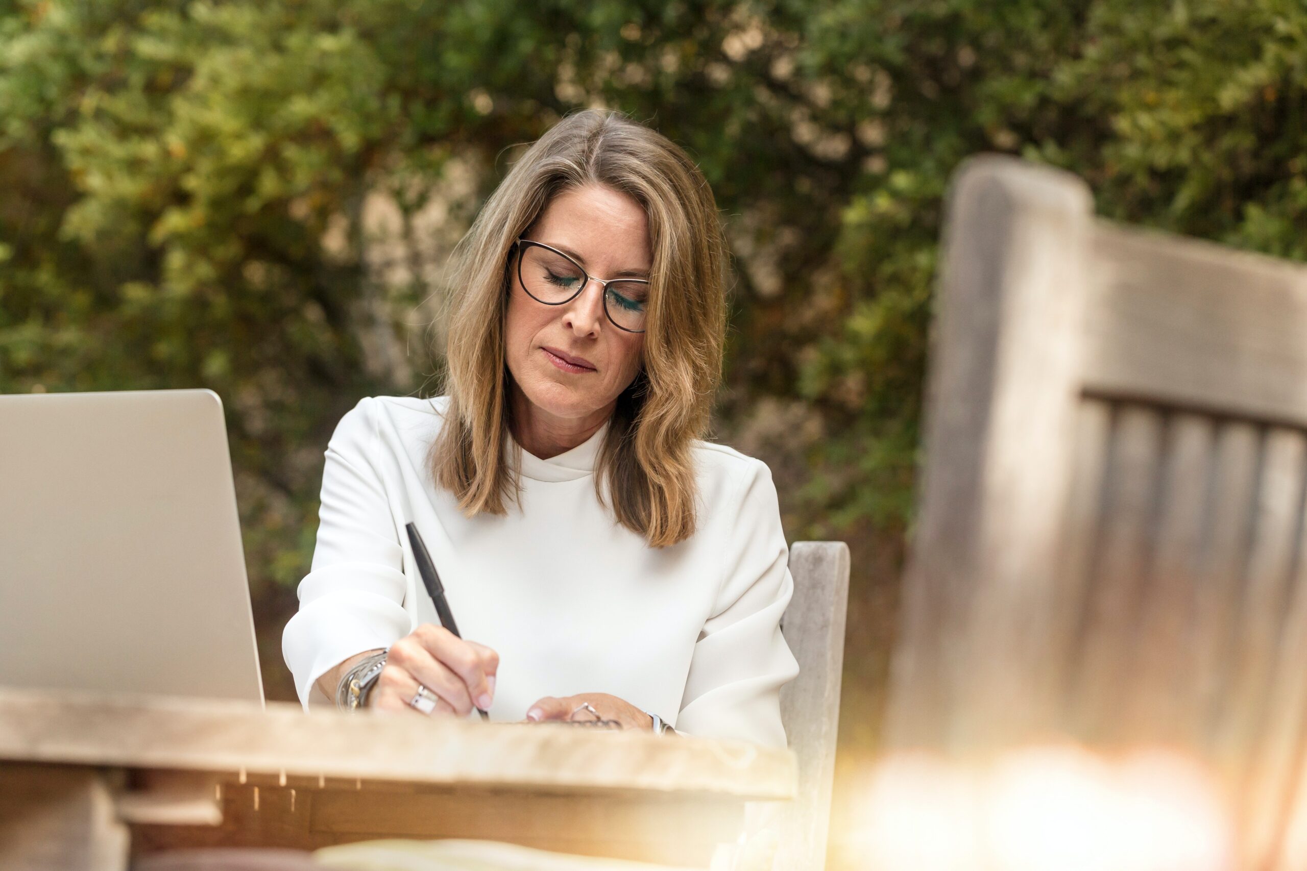 Woman takes notes at computer